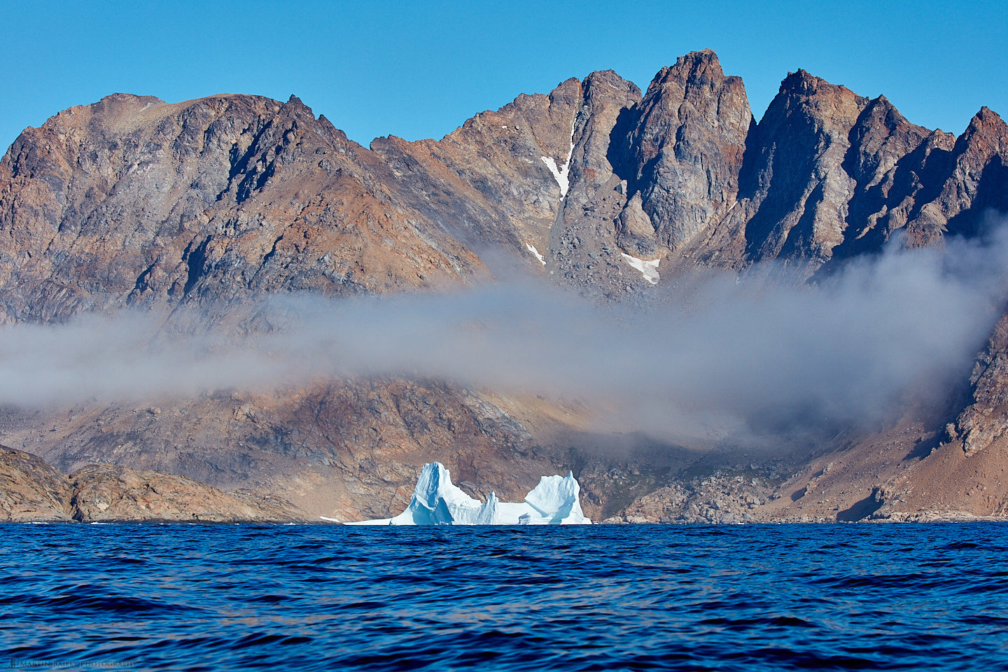 Iceberg with Mist and Mountains