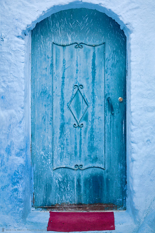Blue Door with Red Doormat